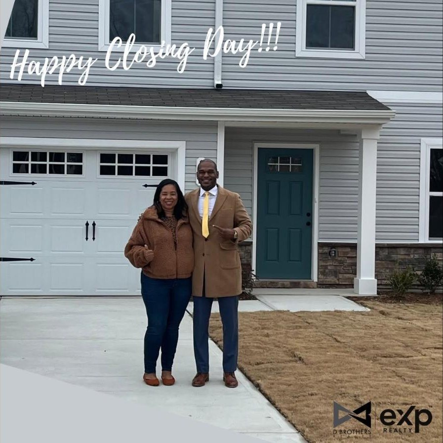 Darren Brothers with a client in front of her new home